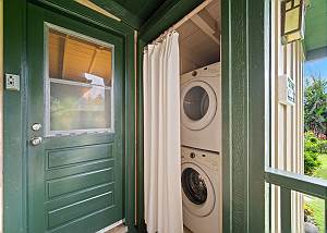 Washer and dryer located by the entry door in the back