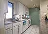 Full-size appliances and everything needed to prepare meals at home.