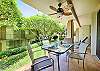 Outdoor dining table overlooking gardens and tropical greenery.