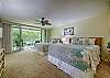 Second angle of the bedroom showcasing greenery outside.