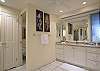 Bright vanity area with updated countertops and storage.