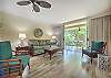 Open-concept living area with natural light and comfortable furnishings.