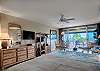 Spacious bedroom with flat-screen TV and sliding doors that open to the lanai overlooking the Maui Eldorado grounds.