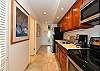 Well-equipped galley kitchen featuring stainless steel appliances, granite counters, and all the essentials for home-style cooking.