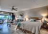 Bright living and dining area with large sliding doors opening to a spacious lanai and views across the Maui Eldorado grounds toward the ocean.