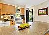Kitchen showing modern finishes and convenient bar seating.