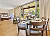Dining table set near large sliding doors, creating an open, airy dining experience.