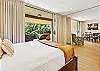 A bright bedroom filled with natural light coming from the lanai.