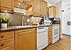 Kitchen with full-size appliances and ample counter space, perfect for home-cooked meals.