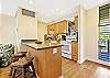 A bright, inviting kitchen with wood cabinetry and clean countertops.
