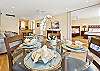 A bright, welcoming dining space set for a meal, showcasing the open-concept layout.