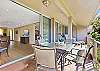 A beautiful combined living and dining area with plenty of natural light flowing through sliding glass doors.