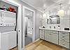 Convenient in-unit washer and dryer located just steps from the beautifully updated double-sink vanity and bathroom.