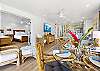 Beautiful dining setup with views into the bedroom and direct access to the lanai overlooking lush greenery.