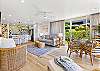 Bright and airy open-concept space featuring a modern kitchen, comfortable living area, and garden-view dining nook.