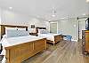 Bright and spacious bedroom featuring two comfortable queen beds with modern coastal décor.