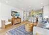Comfortable living space with mounted flat-screen TV and a clear view into the beautifully updated kitchen.