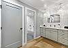 Beautifully remodeled bathroom featuring a spacious walk-in shower and a large double-sink vanity with modern fixtures.
