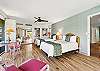 Spacious and inviting bedroom featuring two queen beds, coastal décor, and plenty of natural light.