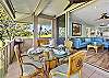 Inviting lanai dining area that opens seamlessly to the living room, offering peaceful garden and golf course views.