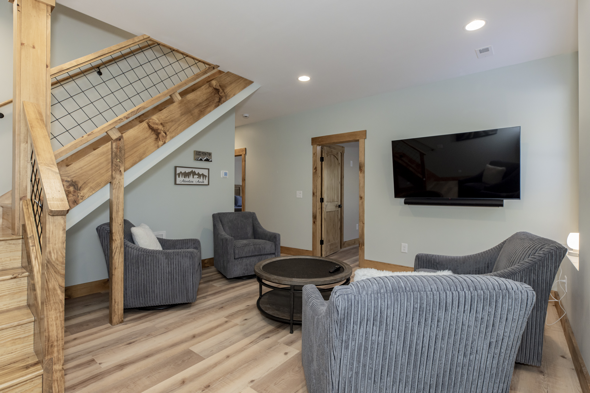 Basement level lounge with flat screen TV and comfy seating