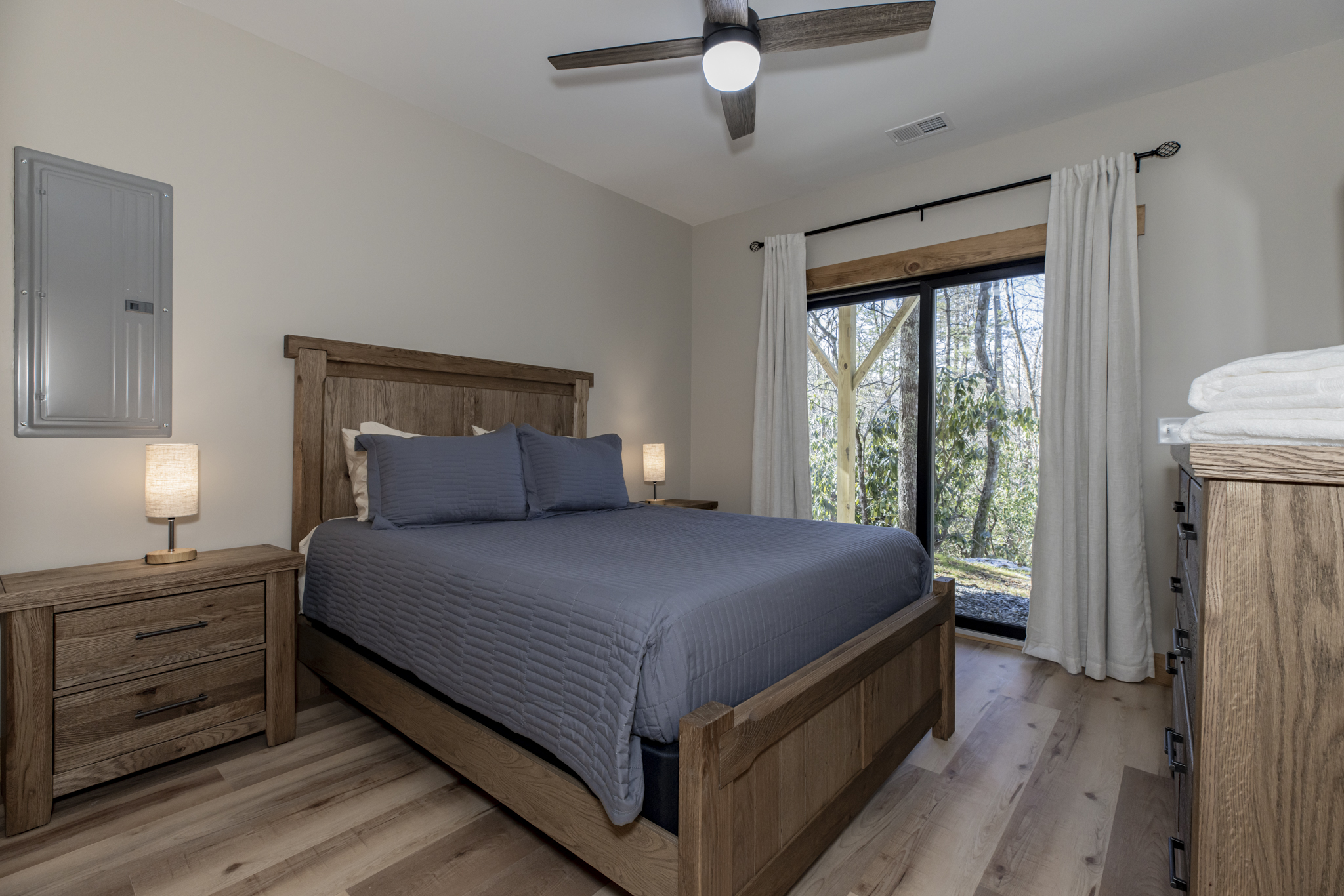 Basement level Queen bedroom with flat screen TV and sliders to 