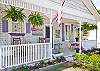 Front exterior of Inlet Breeze cottage. Notice the fantastic white picket fence and all of the wonderful details and colorful shutters and door!
