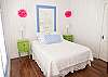 Nighty night! Queen bedroom with lovely white eyelet quilting and bright, fun details. 