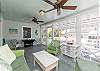 Enjoy breakfast at your table for two on the screened in porch. Relax in the rocking-chair. The screened in porch has two ceiling fans to help you stay cool.  
