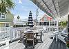Raised deck with ample seating. Table for four and six Adirondack chairs.