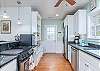 Galley style well appointed kitchen with Jenn Air stove and ample counter space.  