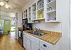 Open cabinets.  Bright and cheery kitchen. 