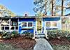 The front of our cottage inside the fenced yard. The large screened porch is to the left.
