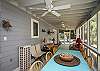 The screened porch has lots of outdoor seating including a table for 4-6.