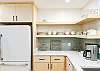 Kitchen updates in summer 2025 include new tile backsplash, open shelving, quartz countertops and cabinetry and lighting updates!