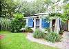Lush tropicalness surrounds this adorable home. 