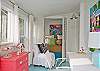 The enclosed back porch is now heated and cooled space.  This area also includes the twin bedroom nook.  A wonderful place to sleep , read and dream the afternoon away!