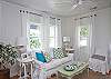 The living room is in the front of the cottage. Cable TV, orginal art and washable white slip covers on all the furniture.  Of yes, and those zebra touches everywhere!