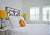 The queen bed headboard is a piece of vintage iron fencing.