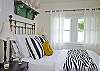 The master bedroom includes the queen bed, master bedroom, sitting area and also acess to screened porch.