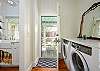 This view shows laundry on right and kitchen on left with view of door leading out to screened porch.