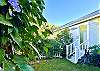 Backyard garden with back entrance to cottage.