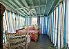 A coastal cottage dream feature...a screened in sleeping porch.  A place to relax, nap, and dream of more days at the beach.   NOTE: THIS IS AN EXTERIOR ROOM; NO HEATING/COOLING.  SCREENED WITH CURTAINS.