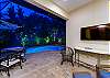 Spacious open living area with 60’’ Smart TV and direct pool views.