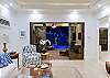Spacious open living area with 60’’ Smart TV and direct pool views.