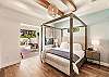 Canopy style king bed with private entrance to patio