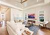 Plush white couch and chairs provide seating for everyone