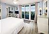 Guest Bedroom with Floor to Ceiling Sliding Glass Doors to Private Juliet Balcony with Views of Intracoastal Waterway