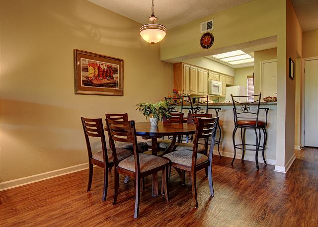 Kitchen table seats six, and the breakfast bar accommodates three.