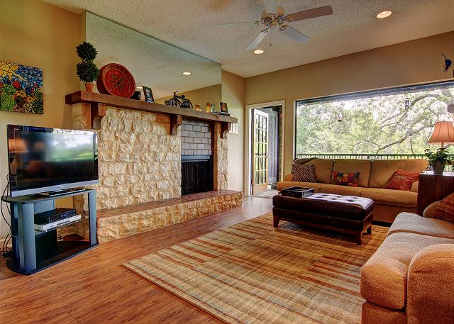 The cozy living room is spacious, and boasts spectacular river views from the scenic window. 
